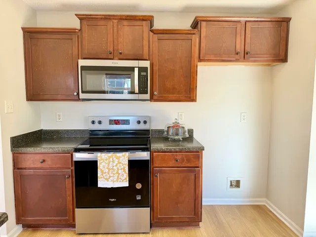 a kitchen with stainless steel appliances granite countertop a stove and a microwave