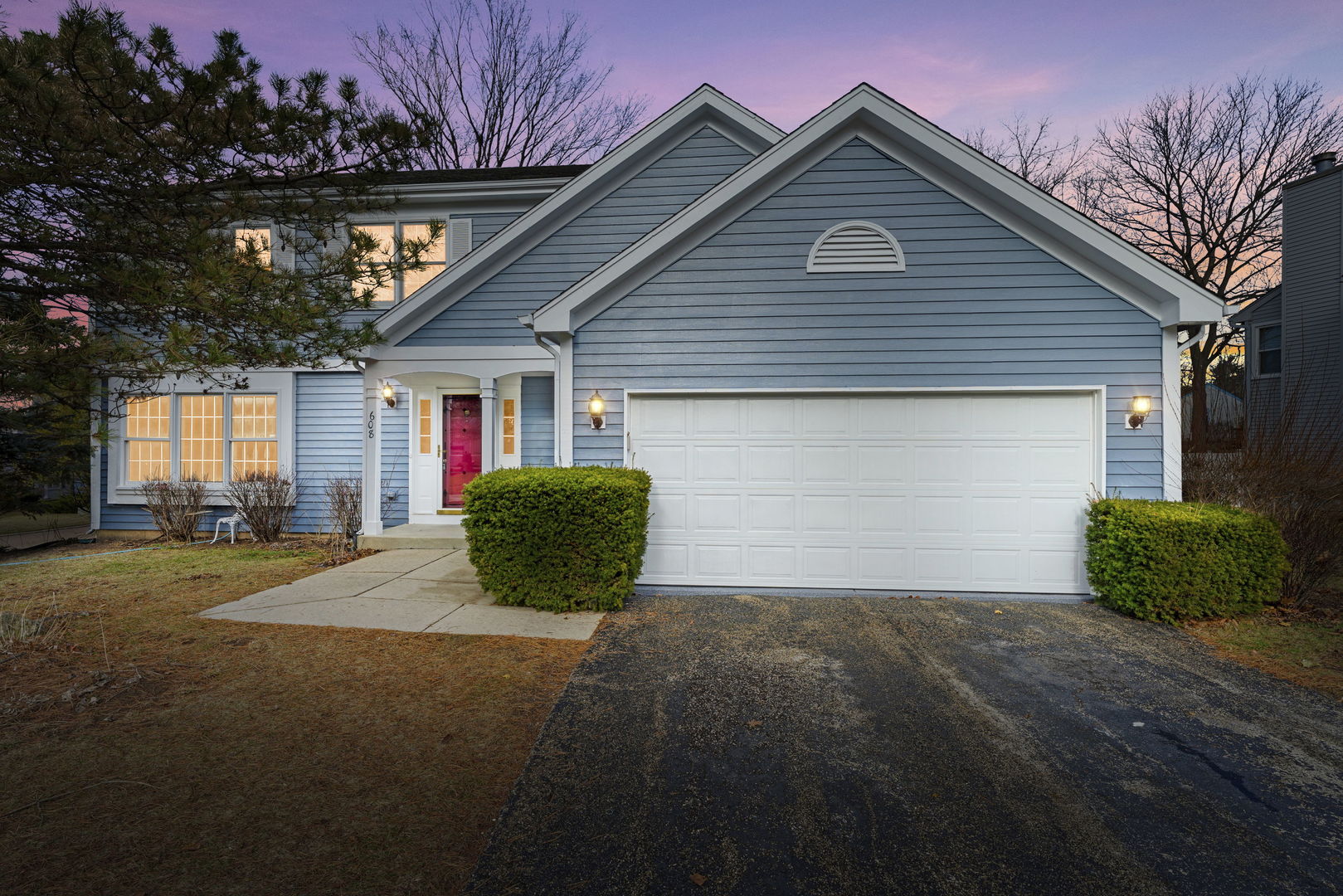 a view of a house with a yard and garage