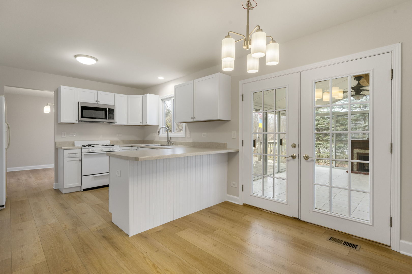 608 Carriage Hill Road Island Lake, IL 60042 - Photo 11 of 28 a kitchen with white cabinets and window