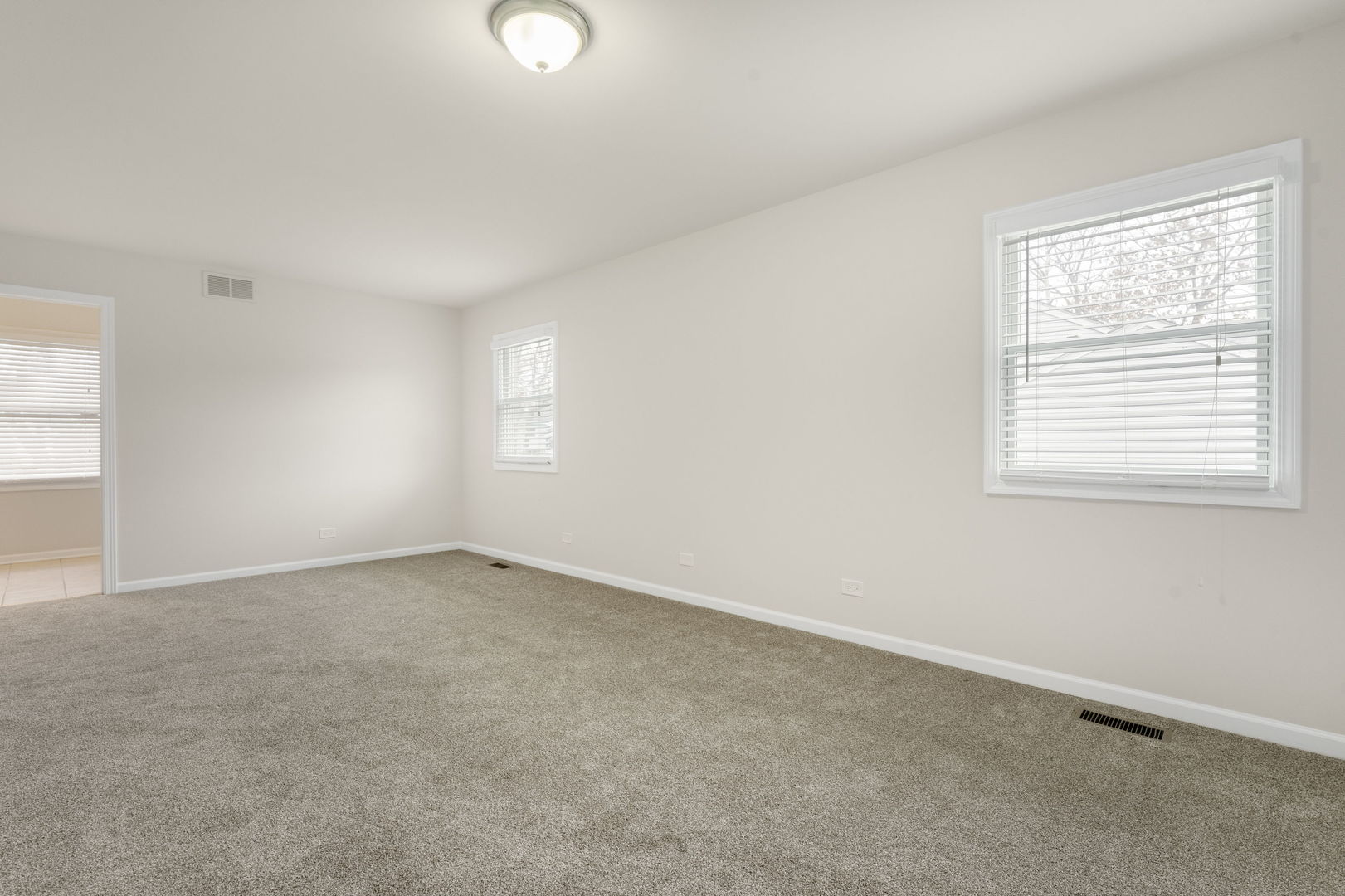 608 Carriage Hill Road Island Lake, IL 60042 - Photo 18 of 28 an empty room with windows