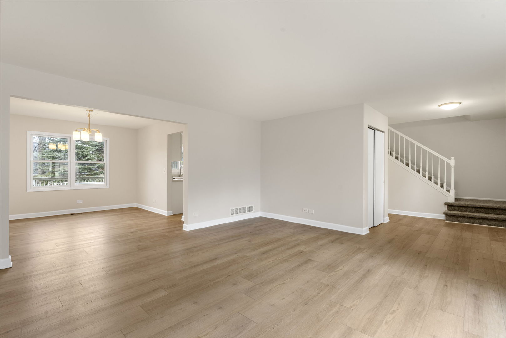 608 Carriage Hill Road Island Lake, IL 60042 - Photo 6 of 28 a view of an empty room with wooden floor and a window
