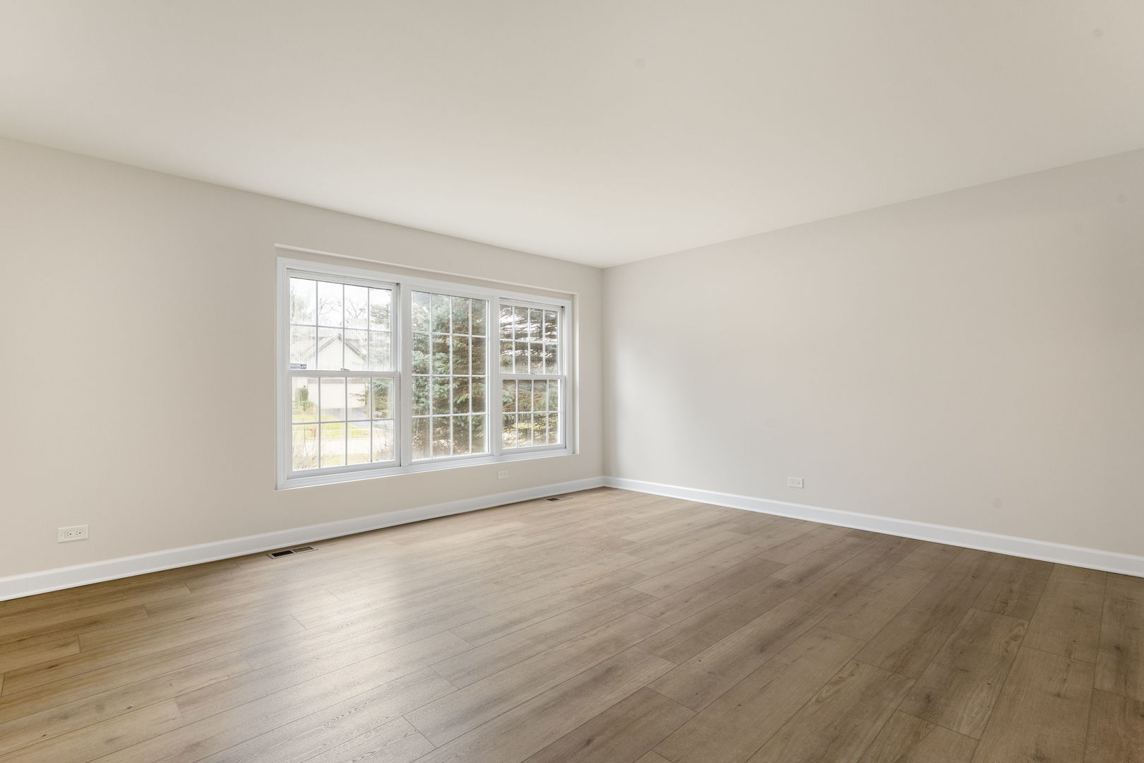 608 Carriage Hill Road Island Lake, IL 60042 - Photo 8 of 28 an empty room with wooden floor and windows