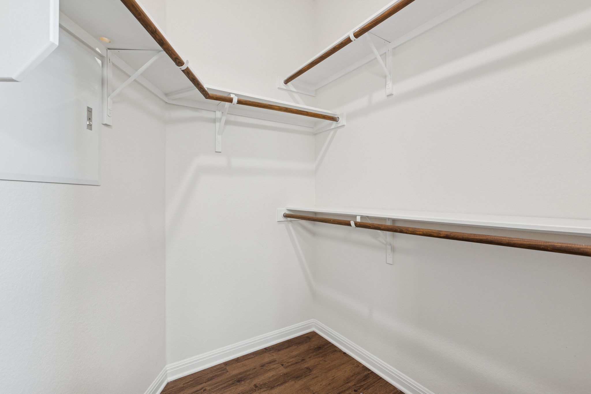 6104 Steep Cactus Trail Austin, TX 78735 - Photo 11 of 17 This closet features white walls, white shelving, and wooden hanging rods, providing ample storage space