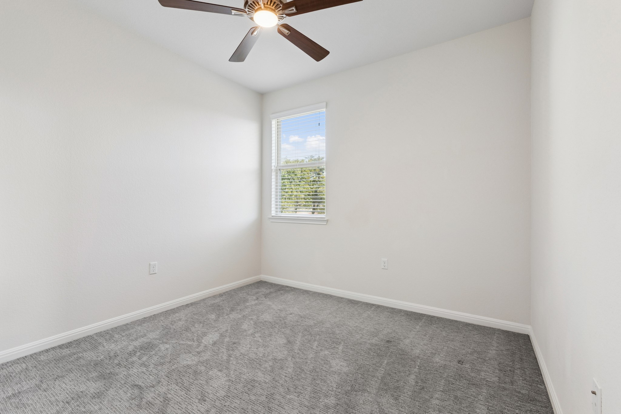 6104 Steep Cactus Trail Austin, TX 78735 - Photo 13 of 17 This room features gray carpeting, white walls, a window with blinds, and a ceiling fan