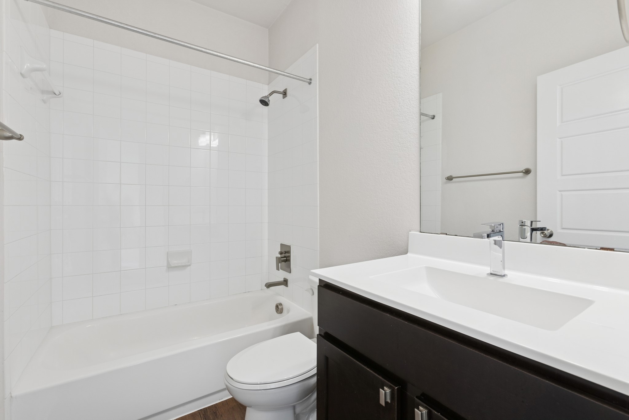 6104 Steep Cactus Trail Austin, TX 78735 - Photo 17 of 17 Bathroom featuring a white subway tiled shower and tub combination, a modern vanity with a white countertop and rectangular sink, and a chrome faucet