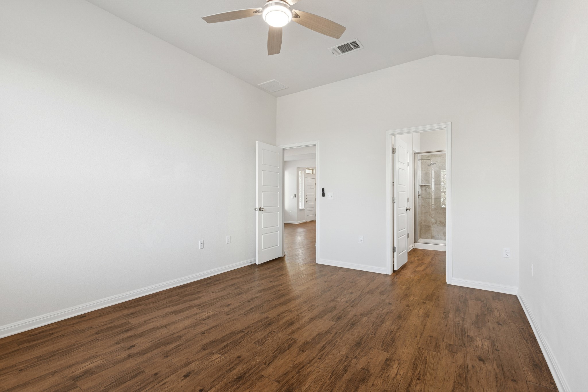 6104 Steep Cactus Trail Austin, TX 78735 - Photo 9 of 17 This room features vaulted ceilings, wood-look flooring, and a ceiling fan