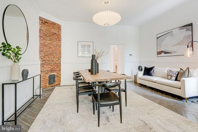 a kitchen with stainless steel appliances granite countertop a stove a refrigerator a sink dishwasher with a dining table and chairs