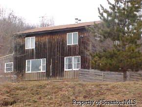 2296 Booth Road Hallstead, PA 18801 - Photo 1 of 1 a view of wooden house with large windows