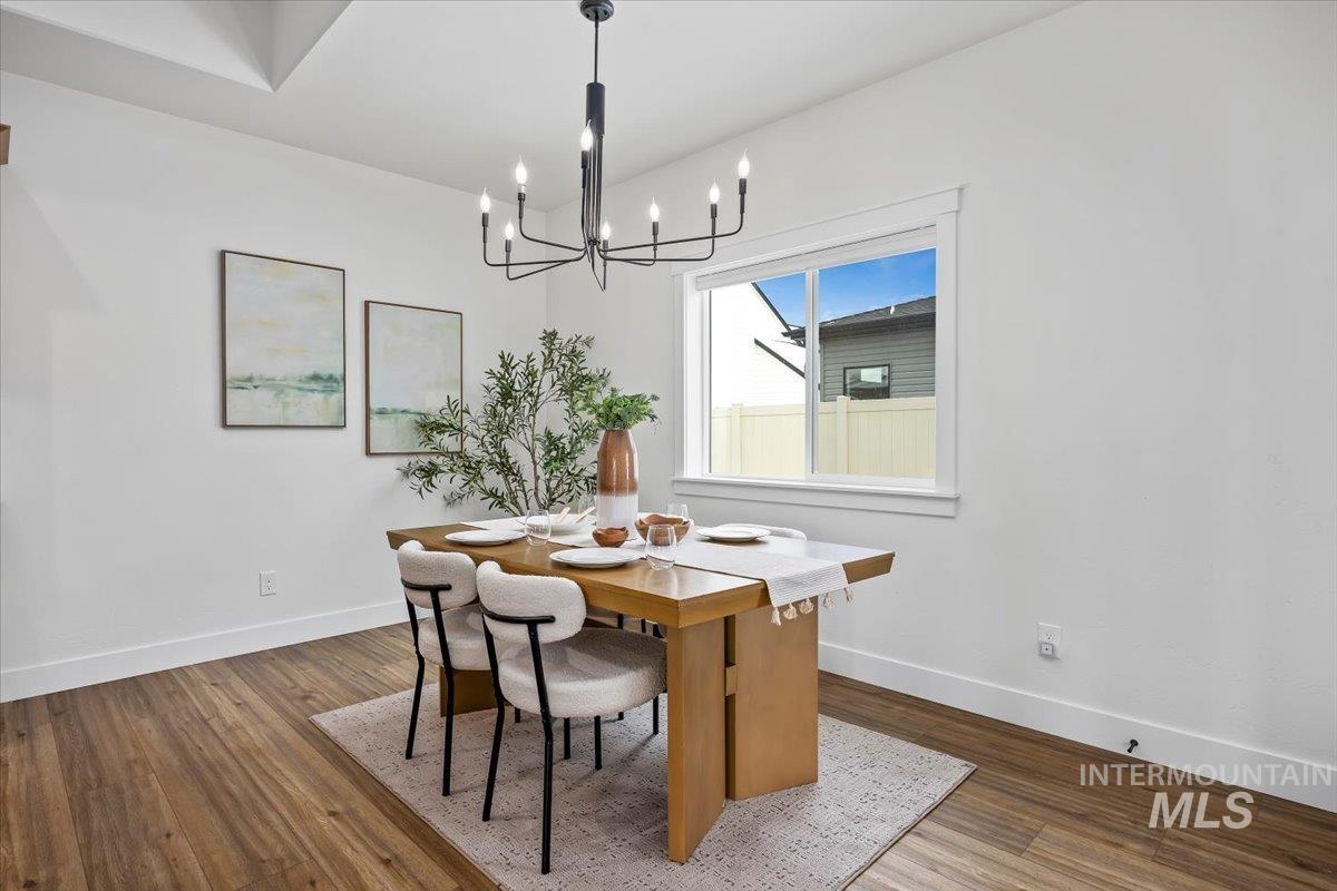 924 Trapper Peak Road Kimberly, ID 83341 - Photo 18 of 40 Dining area featuring dark wood finished floors and a chandelier