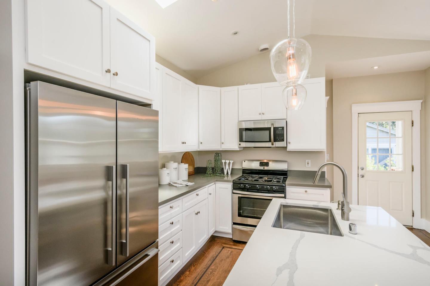 12 Dwight Road Burlingame, CA 94010 - Photo 10 of 34 a kitchen with stainless steel appliances granite countertop a refrigerator a stove a sink dishwasher and white cabinets with wooden floor