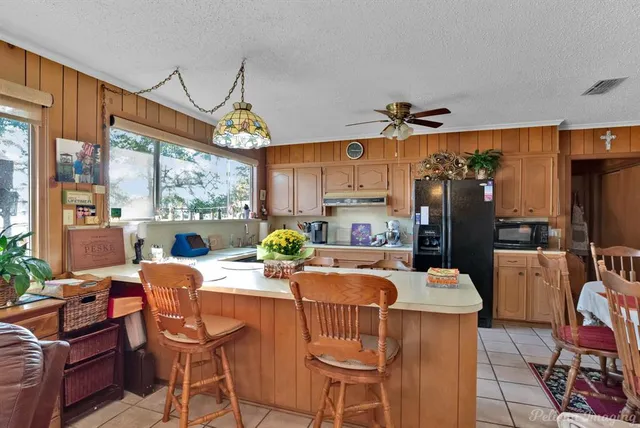 a dining room with furniture a chandelier and wooden floor