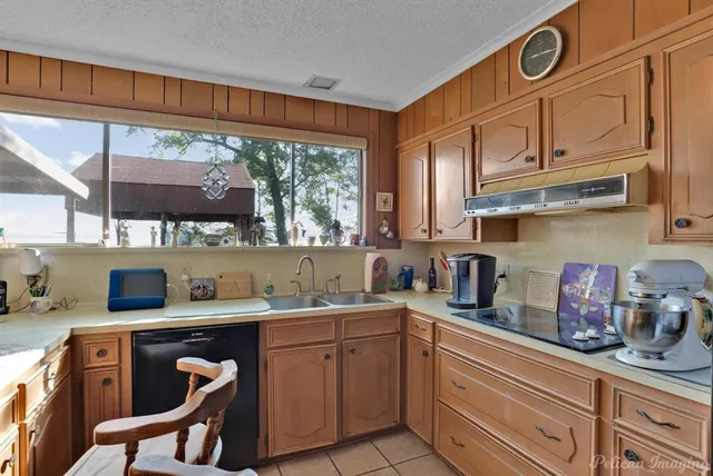 a kitchen with a sink cabinets and window