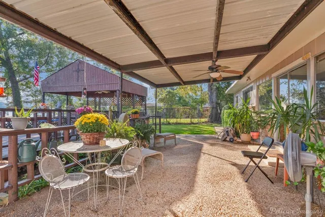 a patio with yard and outdoor seating