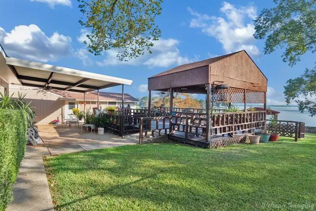 a view of a house with a yard and sitting area