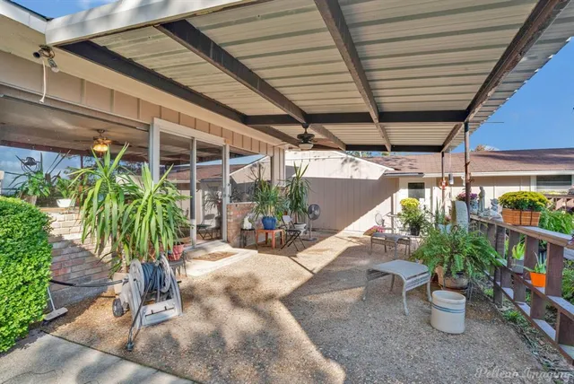 a view of a porch with potted plants