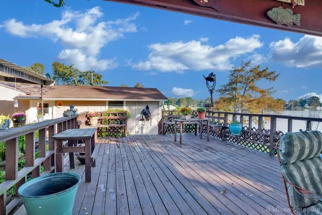 a view of a patio with dining table and chairs with wooden floor
