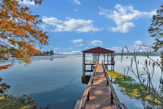 a view of a lake with a table and chairs