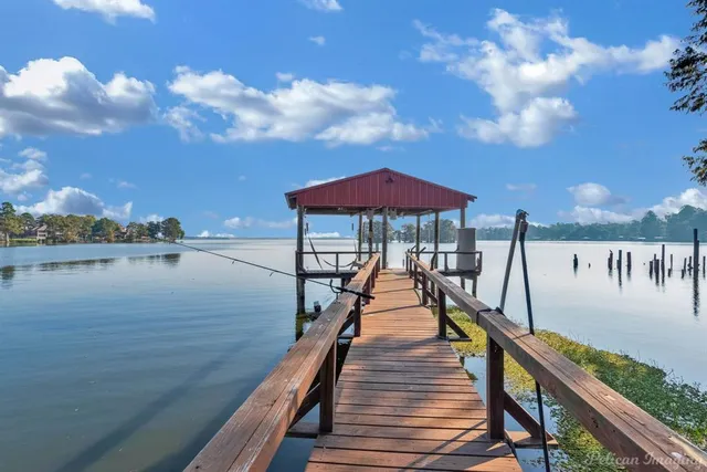 a lake view with a wooden bridge