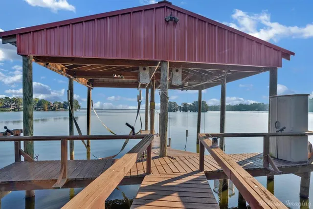 a view of a balcony with wooden floor and outdoor seating