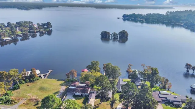 a swimming pool with trees in the background
