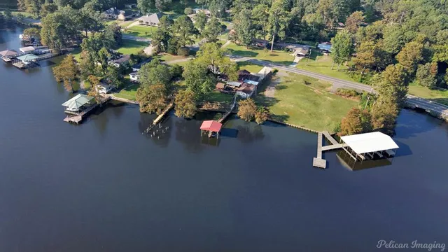 an aerial view of a house with a yard swimming pool a yard and a outdoor seating