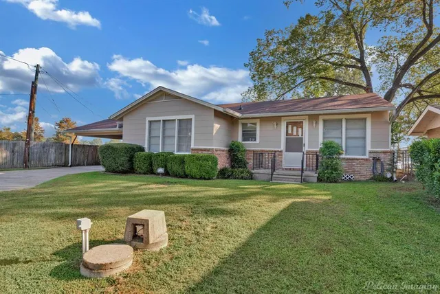 a front view of house with yard and green space