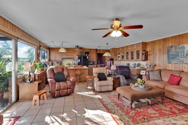 a living room with furniture a rug and a chandelier