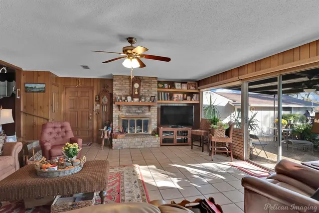 a living room with furniture a rug and a flat screen tv