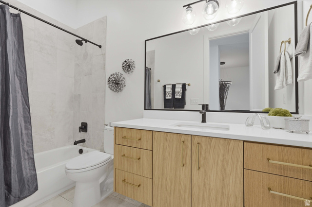 653 East Vandalay Lane Draper, UT 84020 - Photo 29 of 61 Bathroom featuring a wood-finish double vanity with a white countertop and integrated sink, a large wall-mounted mirror, and a tub/shower combination with light-colored tile surround and matte black fixtures