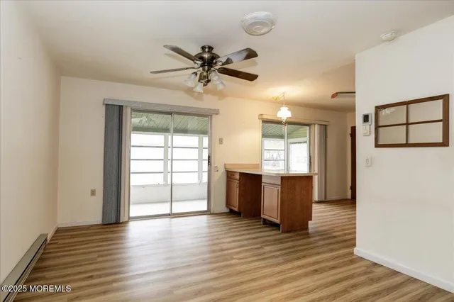 a kitchen with stainless steel appliances granite countertop a stove top oven a refrigerator a sink and dishwasher with wooden floor