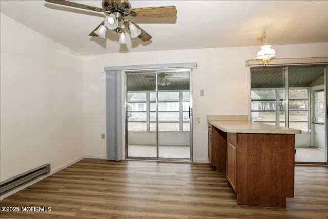 a kitchen with stainless steel appliances a stove a refrigerator a sink and white cabinets