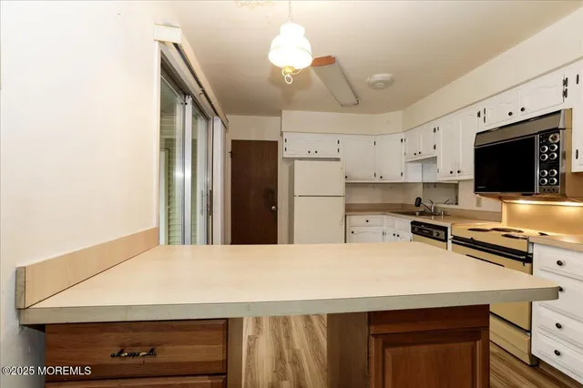 a view of storage and utility room with washer and dryer