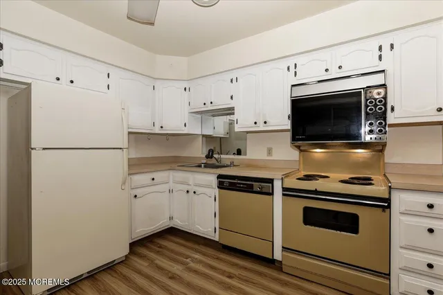 a view of a yard in front of a house with large trees