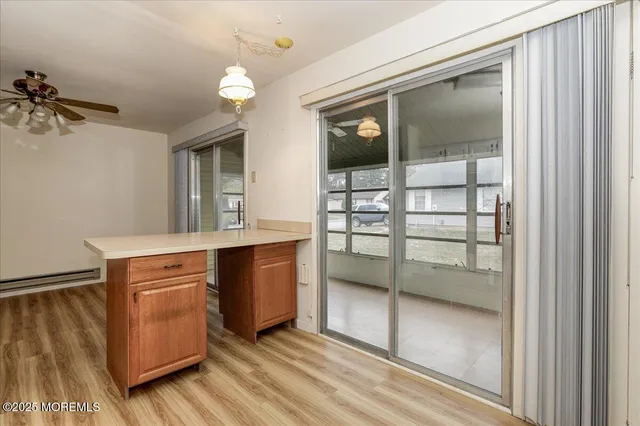 a view of a white house with a yard and large parking space