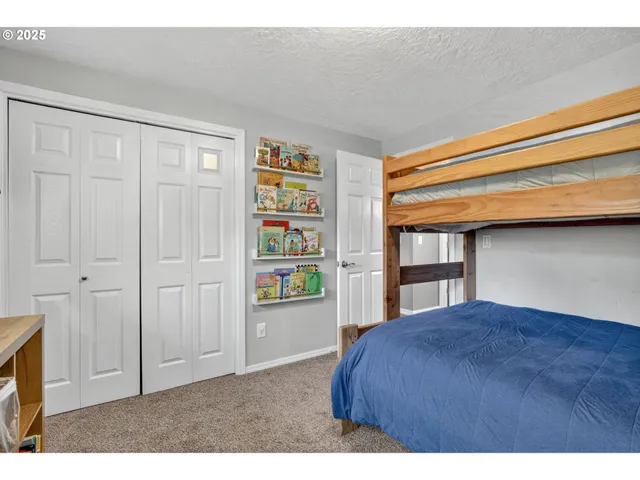 a bedroom with a bed and a book shelf