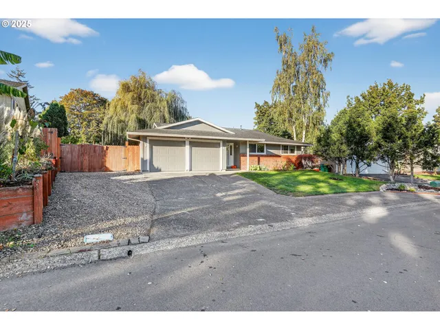 a view of a house with a yard and potted plants