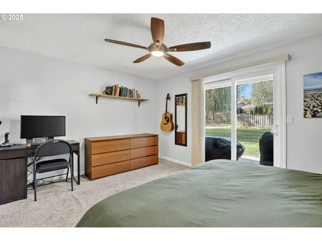 a bedroom with a bed and a large window