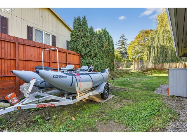 a backyard of a house with table and chairs
