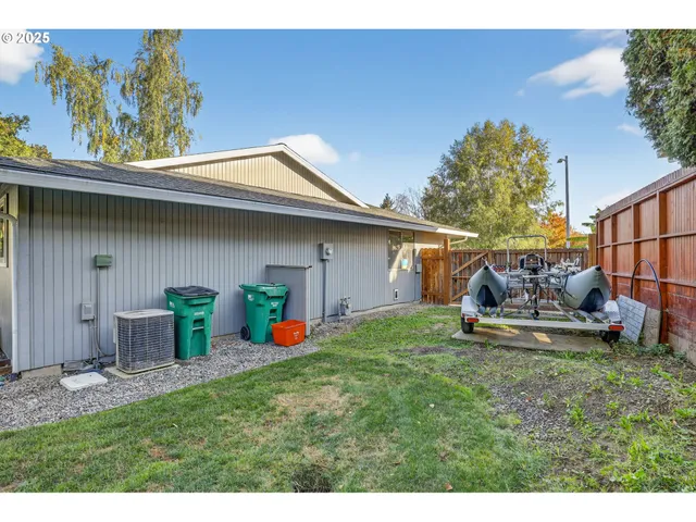 a backyard of a house with table and chairs