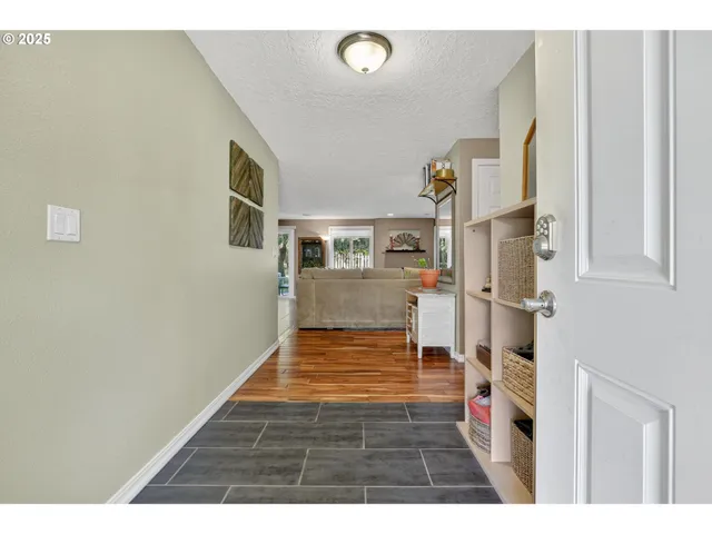 a view of an entryway with wooden floor