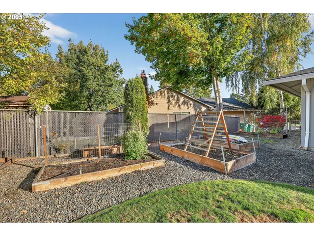 a backyard of a house with table and chairs