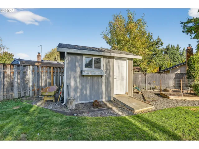 a view of a backyard with table and chairs and potted plants