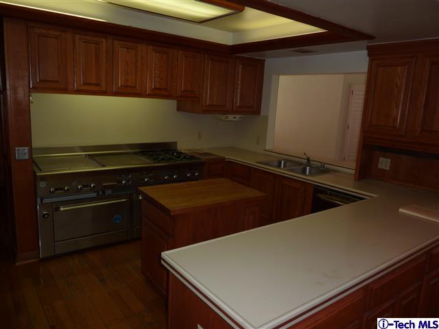 Undisclosed Address Pasadena, CA 91105 - Photo 12 of 50 a kitchen with stainless steel appliances a stove a microwave and a refrigerator