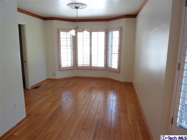 Undisclosed Address Pasadena, CA 91105 - Photo 15 of 50 an empty room with wooden floor and windows