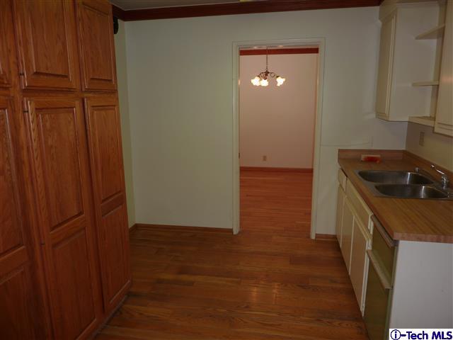 Undisclosed Address Pasadena, CA 91105 - Photo 16 of 50 a kitchen with a refrigerator and cabinets