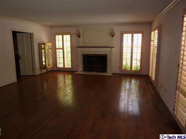 Undisclosed Address Pasadena, CA 91105 - Photo 8 of 50 an empty room with wooden floor fireplace and windows