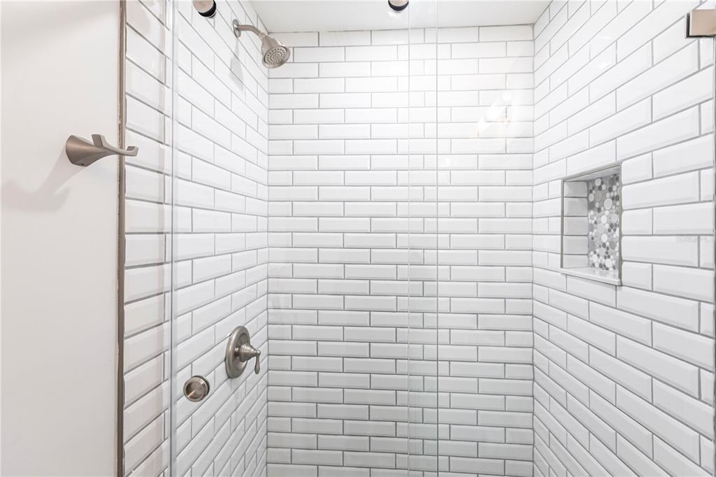 6020 Midnight Pass Road, Unit 27 Sarasota, FL 34242 - Photo 20 of 23 a bathroom with a shower