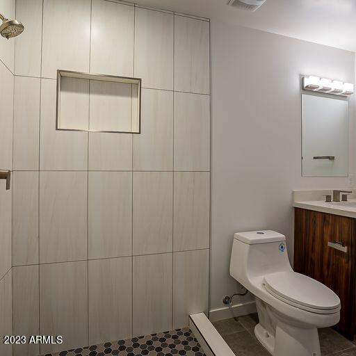 6227 North 13th Place, Unit 1 Phoenix, AZ 85014 - Photo 13 of 16 a white toilet sitting next to a bathroom sink and vanity