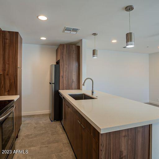6227 North 13th Place, Unit 1 Phoenix, AZ 85014 - Photo 4 of 16 a kitchen with stainless steel appliances granite countertop a sink a stove and a refrigerator