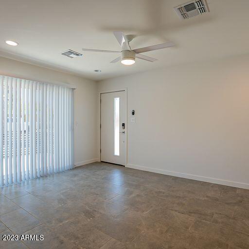 6227 North 13th Place, Unit 1 Phoenix, AZ 85014 - Photo 5 of 16 an empty room with a ceiling fan and window